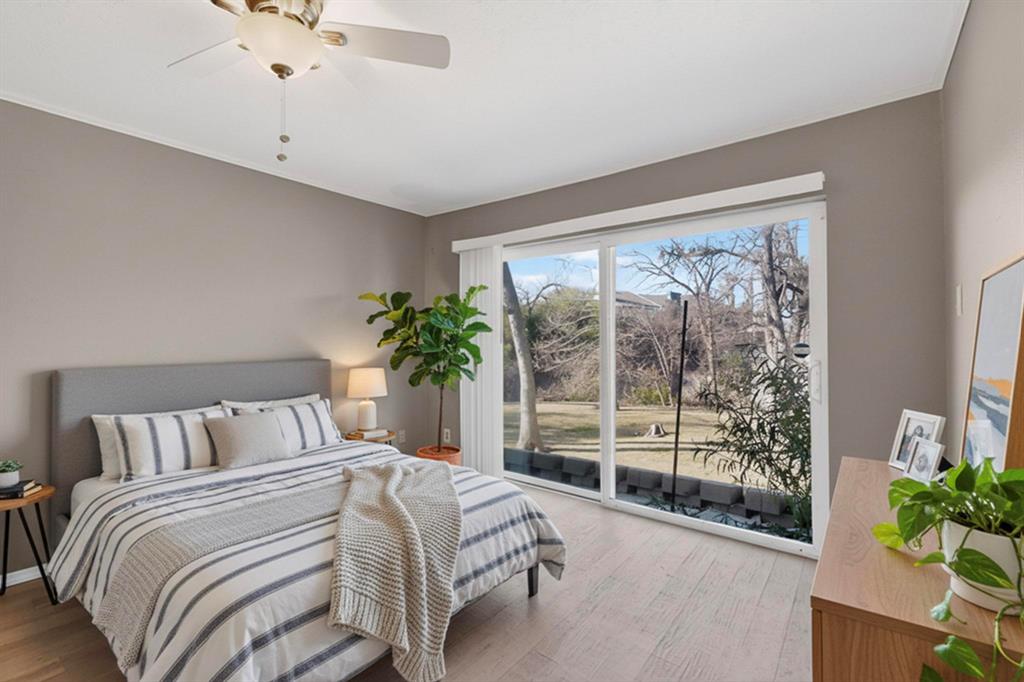 9222 Church Road, Unit 112 Dallas, TX 75231 - Photo 9 of 22 a bedroom with a large bed and a potted plant