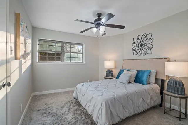 a bedroom with a large bed and a window