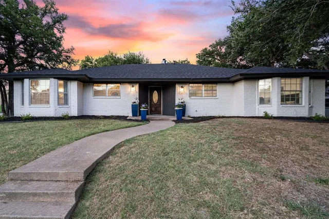 a view of a house with a yard and garage