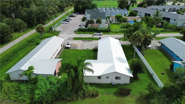an aerial view of a house with yard and green space