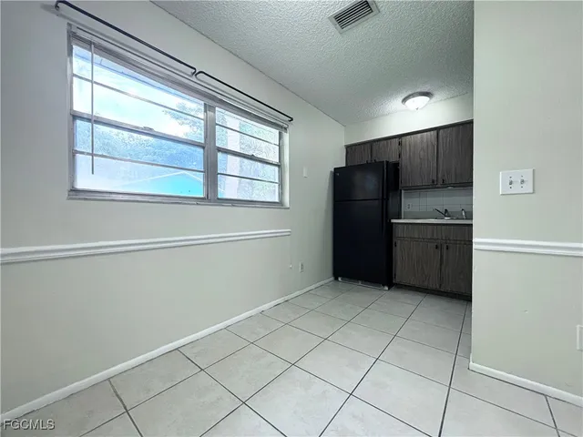 a kitchen with a refrigerator and window