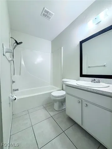 a bathroom with a double vanity sink toilet mirror and bathtub