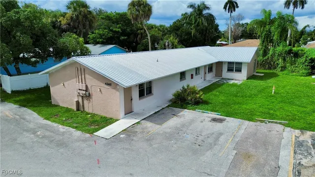 a aerial view of a house with a yard and potted plants