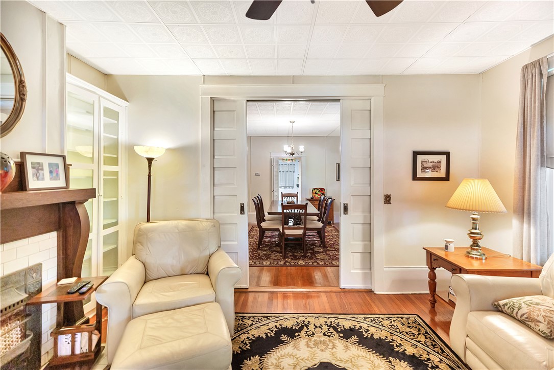 205 West Mauldin Street Walhalla, SC 29691 - Photo 7 of 43 A graceful living room with polished wood floors seamlessly connects to a spacious dining area.