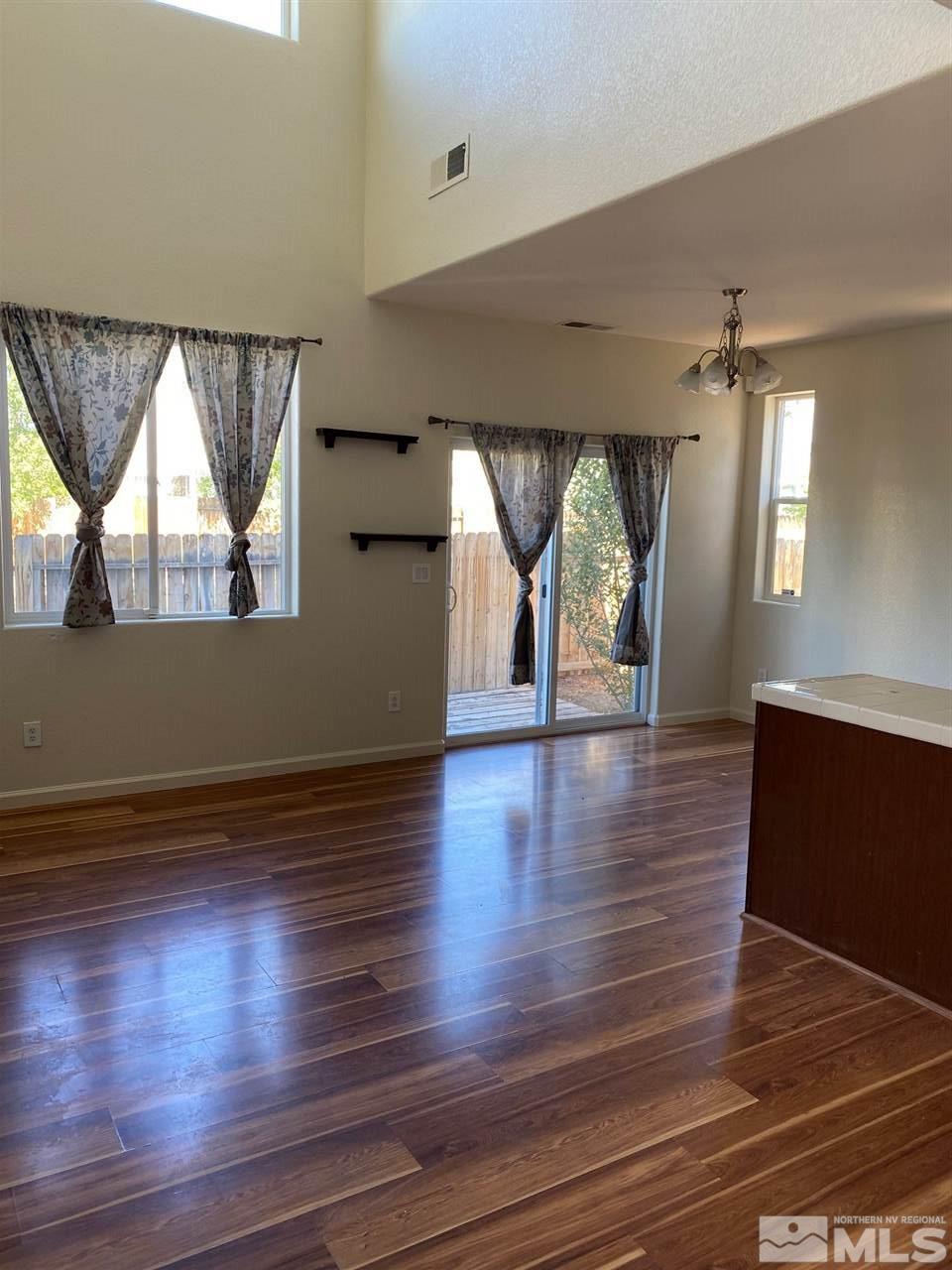 2185 Stanhope Lane Reno, NV 89502 - Photo 4 of 12 wooden floor in an empty room with a window