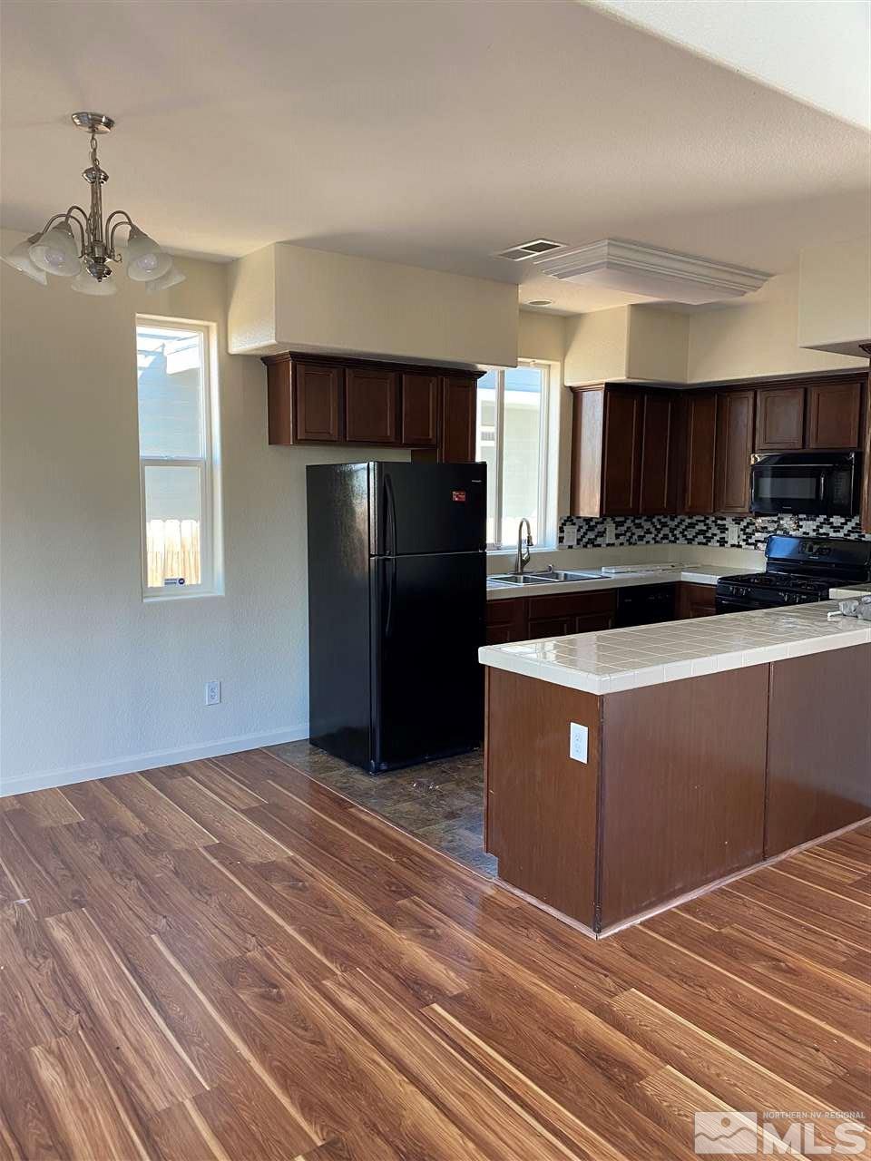 2185 Stanhope Lane Reno, NV 89502 - Photo 6 of 12 a kitchen with stainless steel appliances granite countertop a refrigerator a sink a stove and a microwave