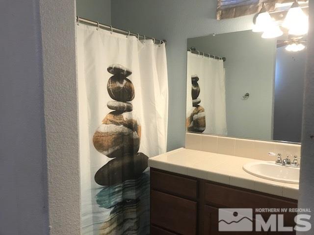 2185 Stanhope Lane Reno, NV 89502 - Photo 8 of 12 a bathroom with a sink and a mirror
