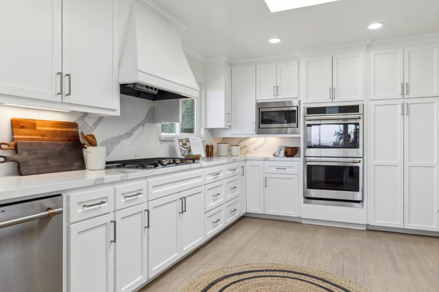 1225 Roble Road Millbrae, CA 94030 - Photo 15 of 42 a kitchen with granite countertop white cabinets and stainless steel appliances