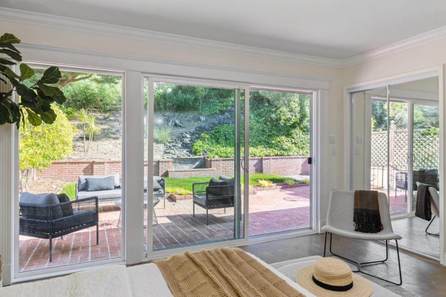 1225 Roble Road Millbrae, CA 94030 - Photo 24 of 42 a living room with hardwood floor and a floor to ceiling window