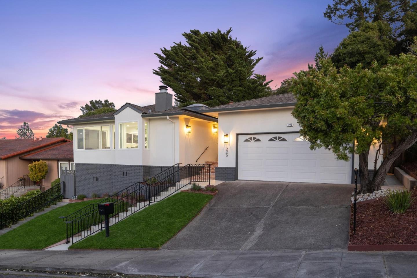 1225 Roble Road Millbrae, CA 94030 - Photo 3 of 42 a front view of a house with a garden and trees
