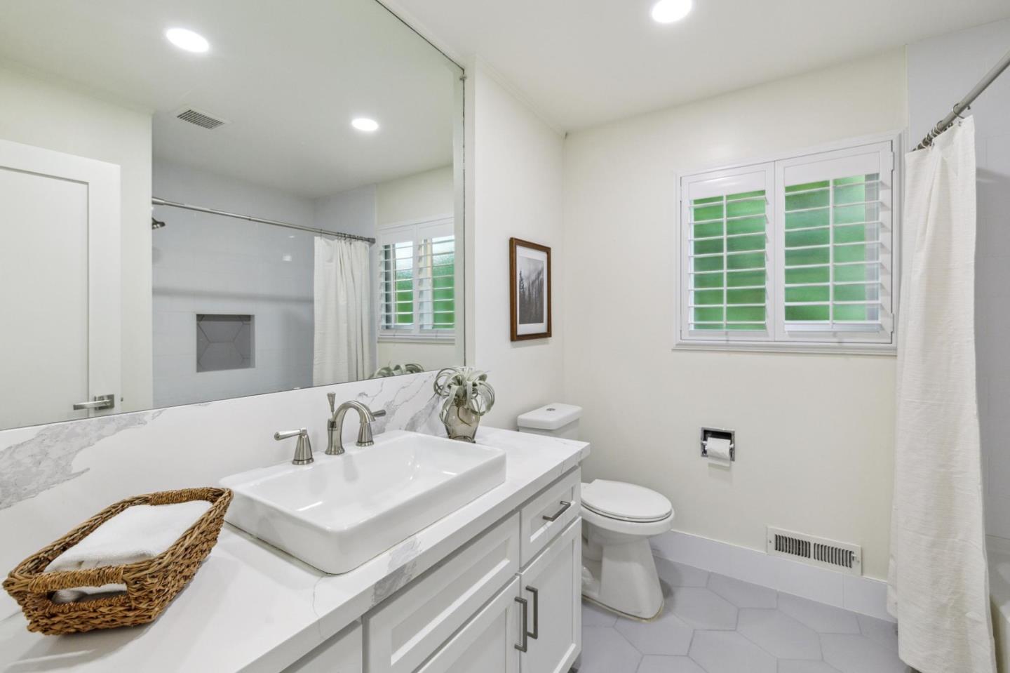 1225 Roble Road Millbrae, CA 94030 - Photo 31 of 42 a bathroom with a granite countertop sink a toilet and a mirror