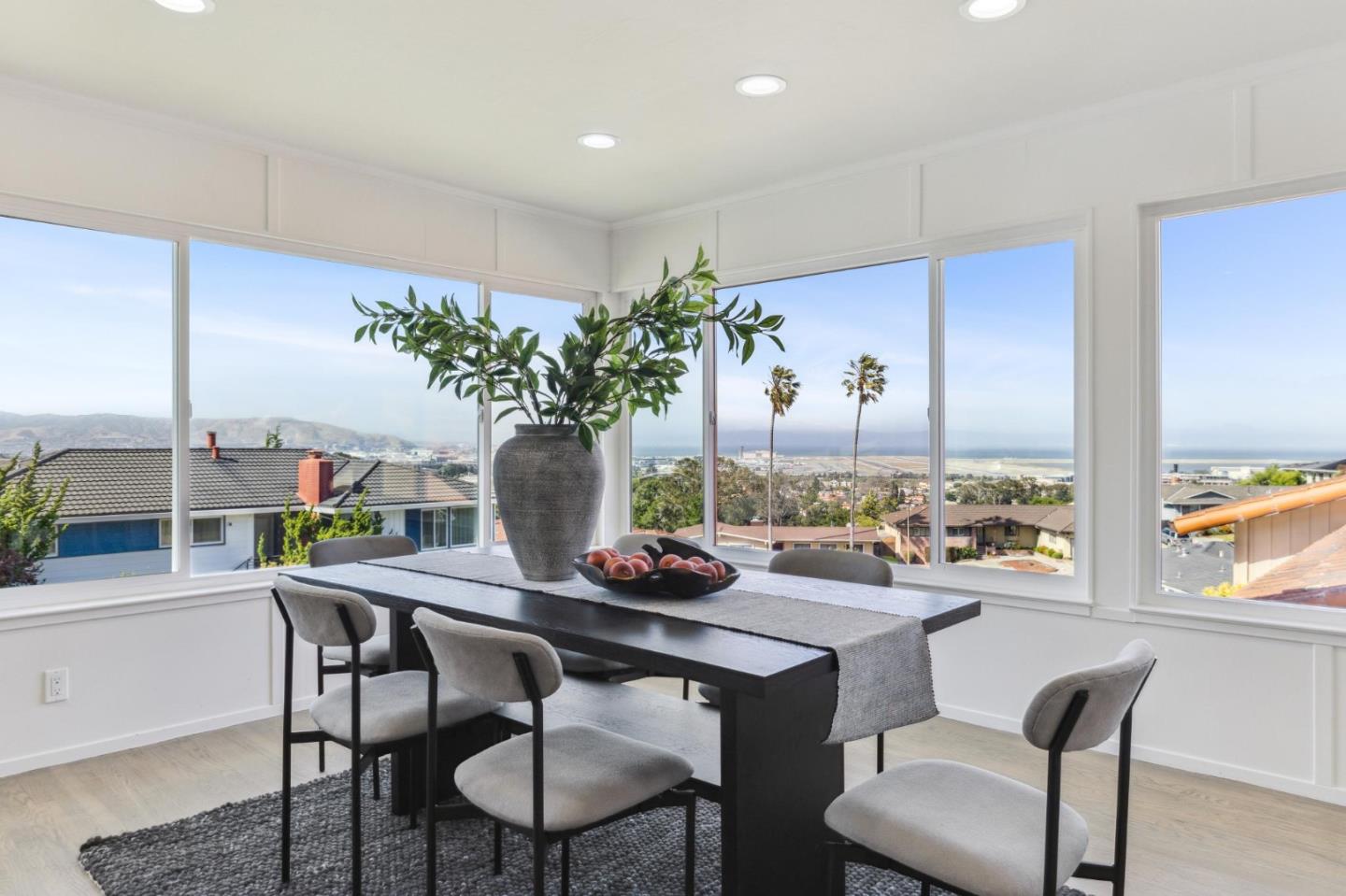 1225 Roble Road Millbrae, CA 94030 - Photo 6 of 42 a dining room with furniture potted plants and wooden floor
