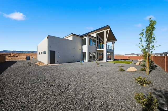 3011 East Rimrunner Drive, Unit 302 St. George, UT 84790 - Photo 40 of 45 Rear view of property featuring stucco siding, a balcony, and a mountain view