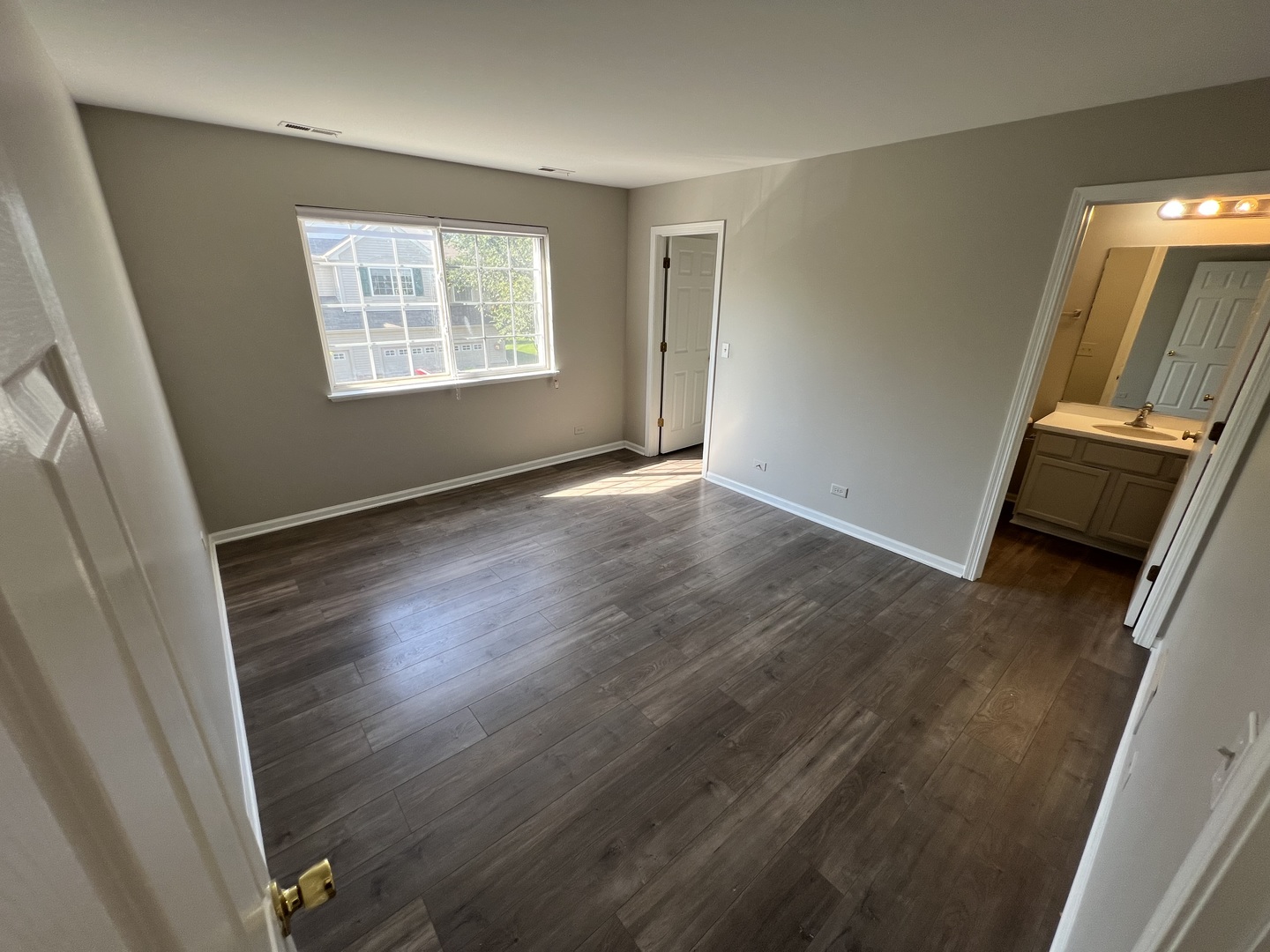 3044 Troon Drive Montgomery, IL 60538 - Photo 11 of 20 a view of an empty room with wooden floor and a window