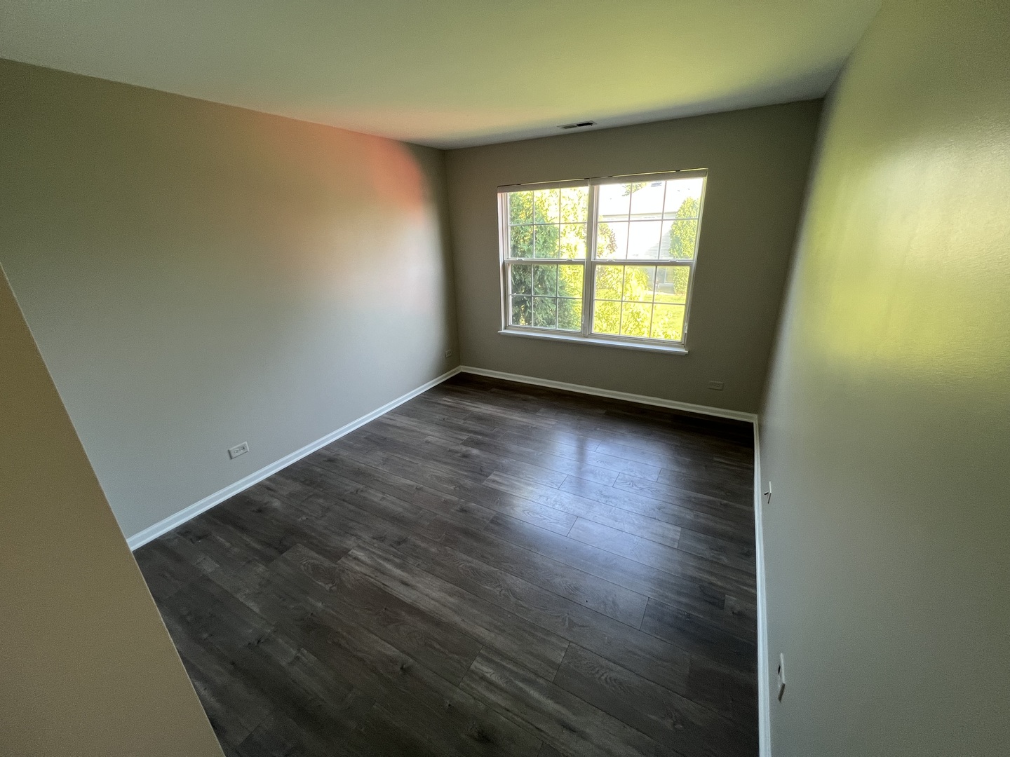3044 Troon Drive Montgomery, IL 60538 - Photo 8 of 20 an empty room with wooden floor and windows