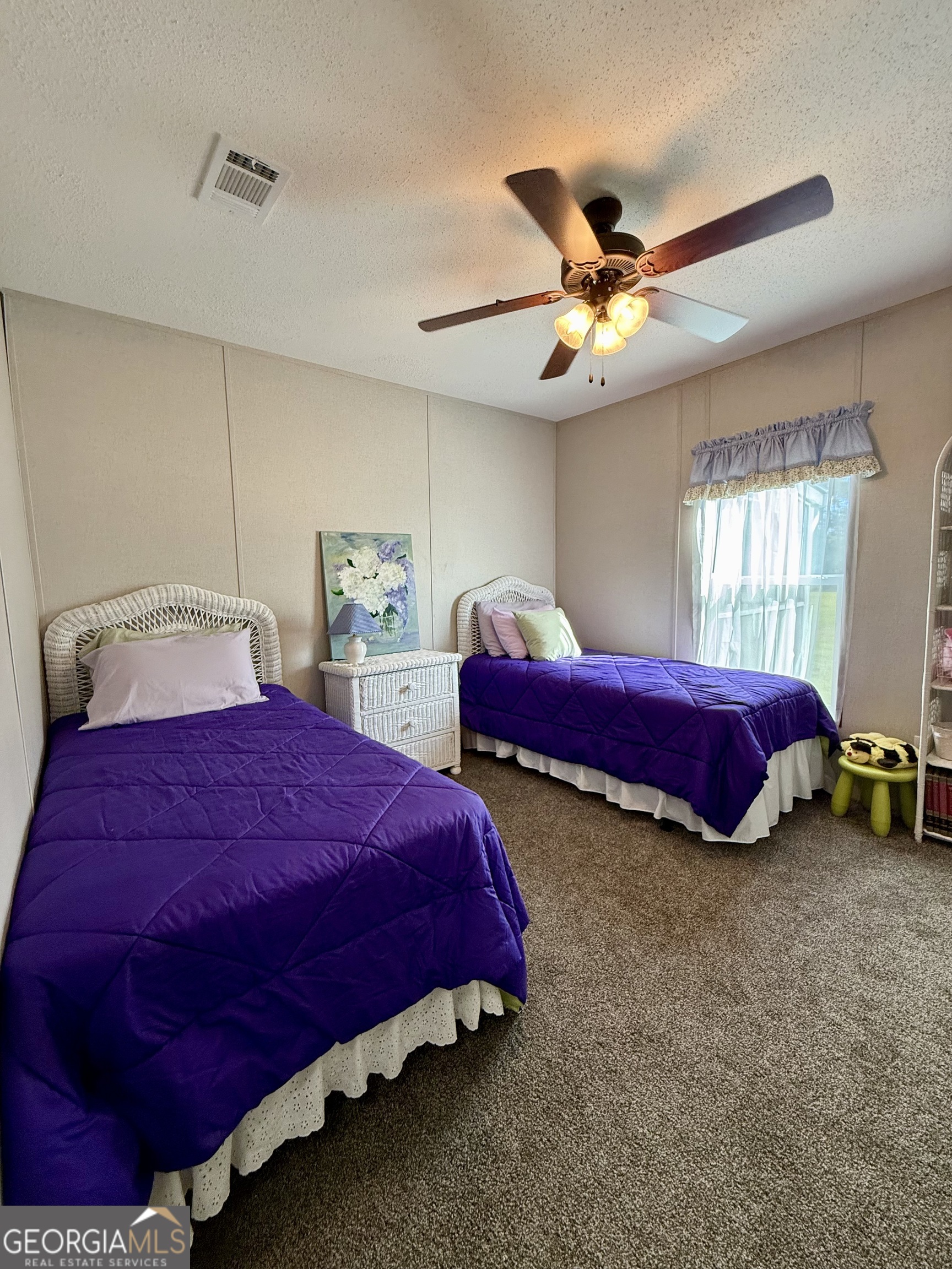 1430 Old Poor Robin Road Sylvania, GA 30467 - Photo 14 of 30 a bedroom with a bed and a chandelier