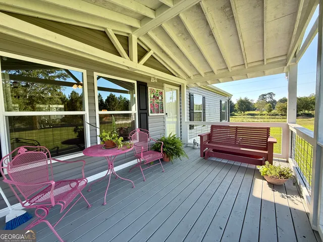 a sitting area with furniture and wooden deck