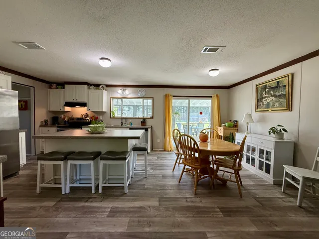 a dining room with furniture and window