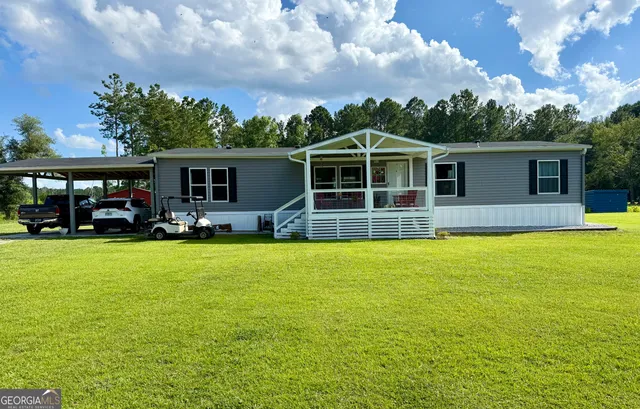 a front view of house with yard and outdoor seating
