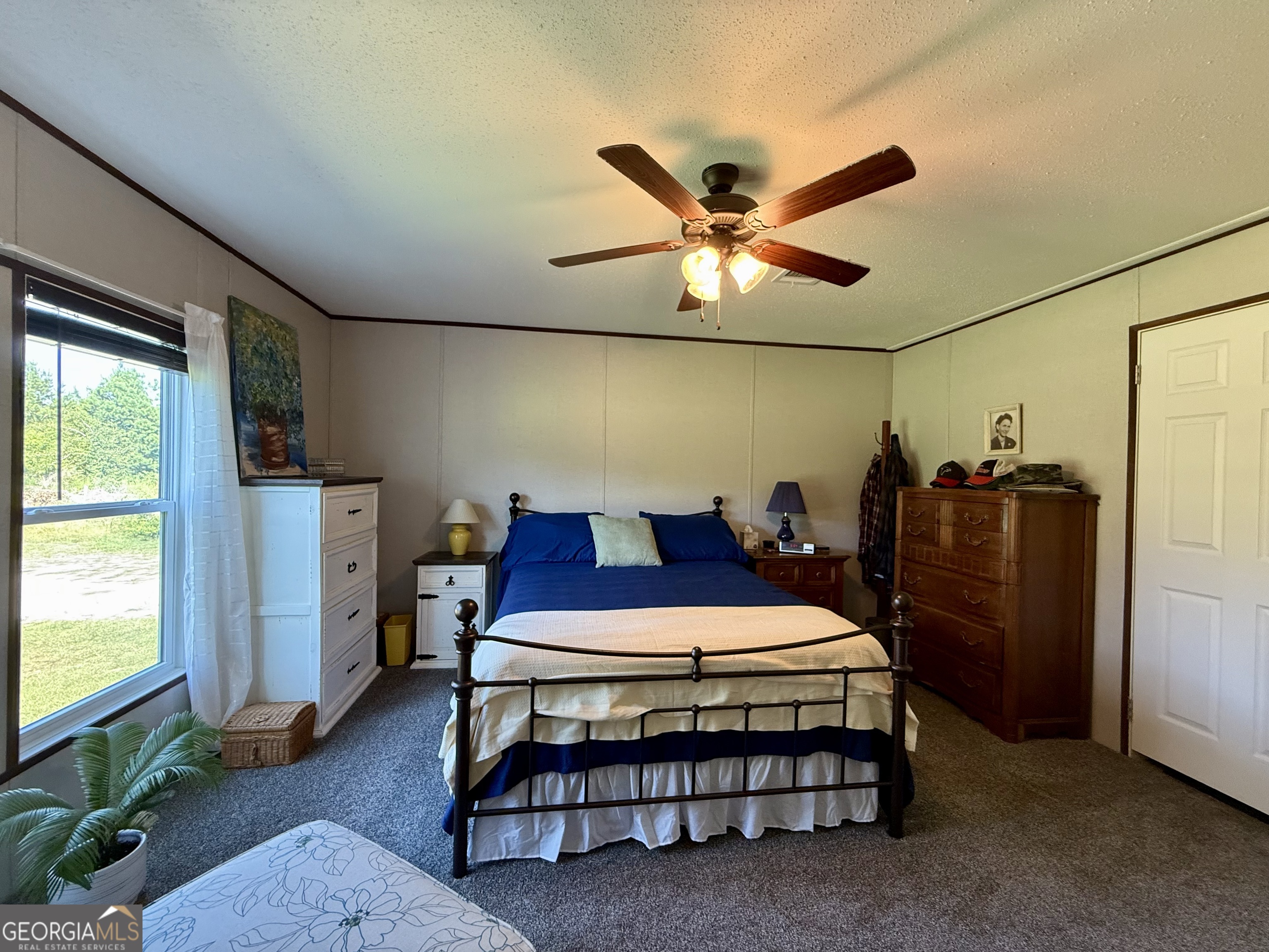 1430 Old Poor Robin Road Sylvania, GA 30467 - Photo 6 of 30 a bedroom with a bed and a chandelier