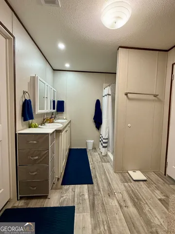 a kitchen with a refrigerator and a stove top oven