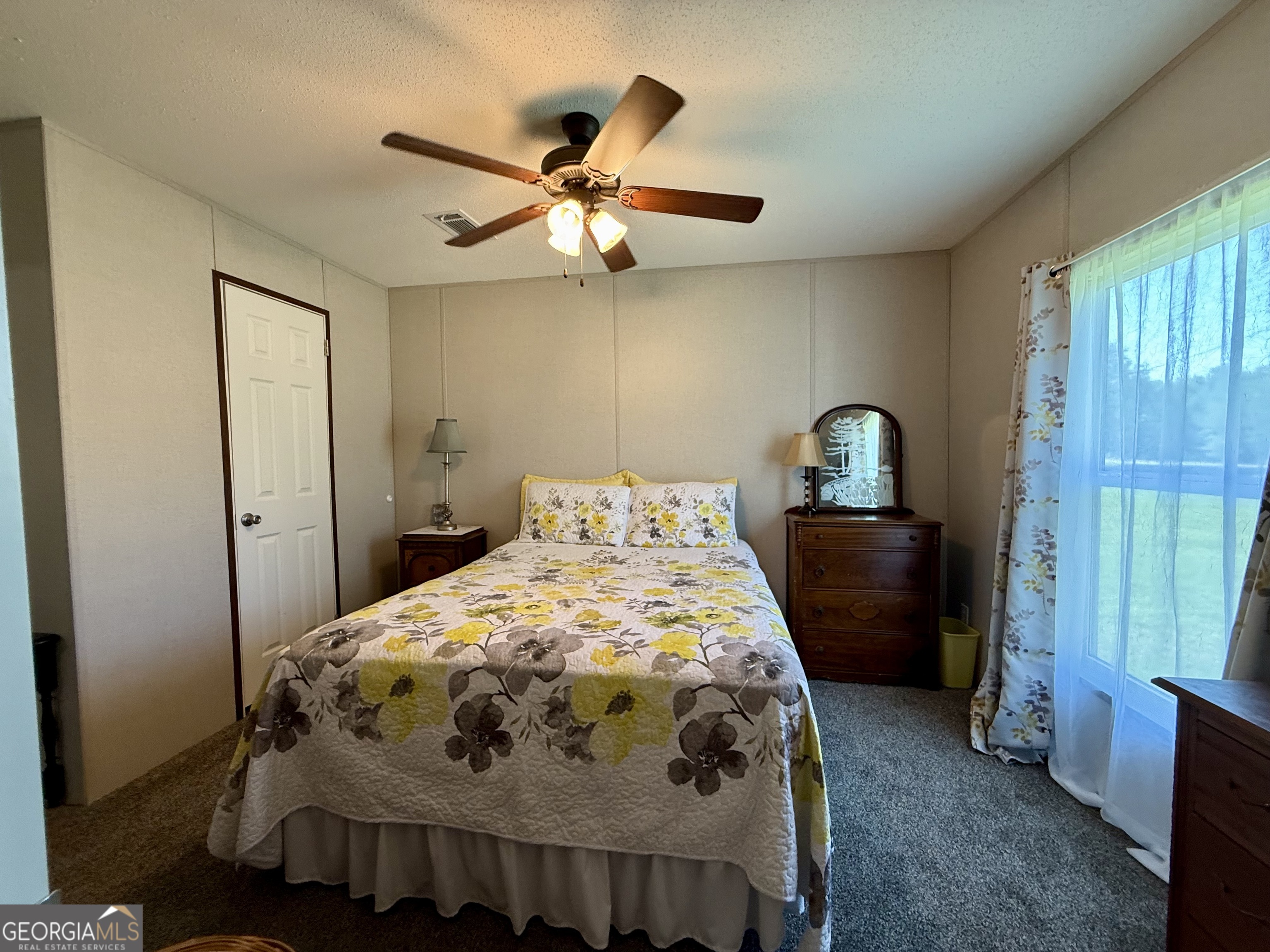 1430 Old Poor Robin Road Sylvania, GA 30467 - Photo 10 of 30 a bedroom with a bed and a chandelier