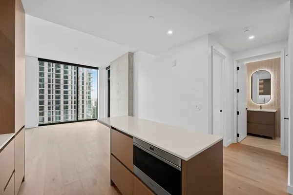 a view of an empty room with a kitchen