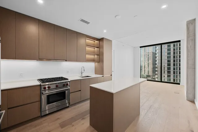 a kitchen with granite countertop a stove and a sink
