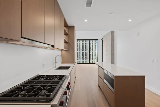 a kitchen with wooden cabinets and a stove top oven