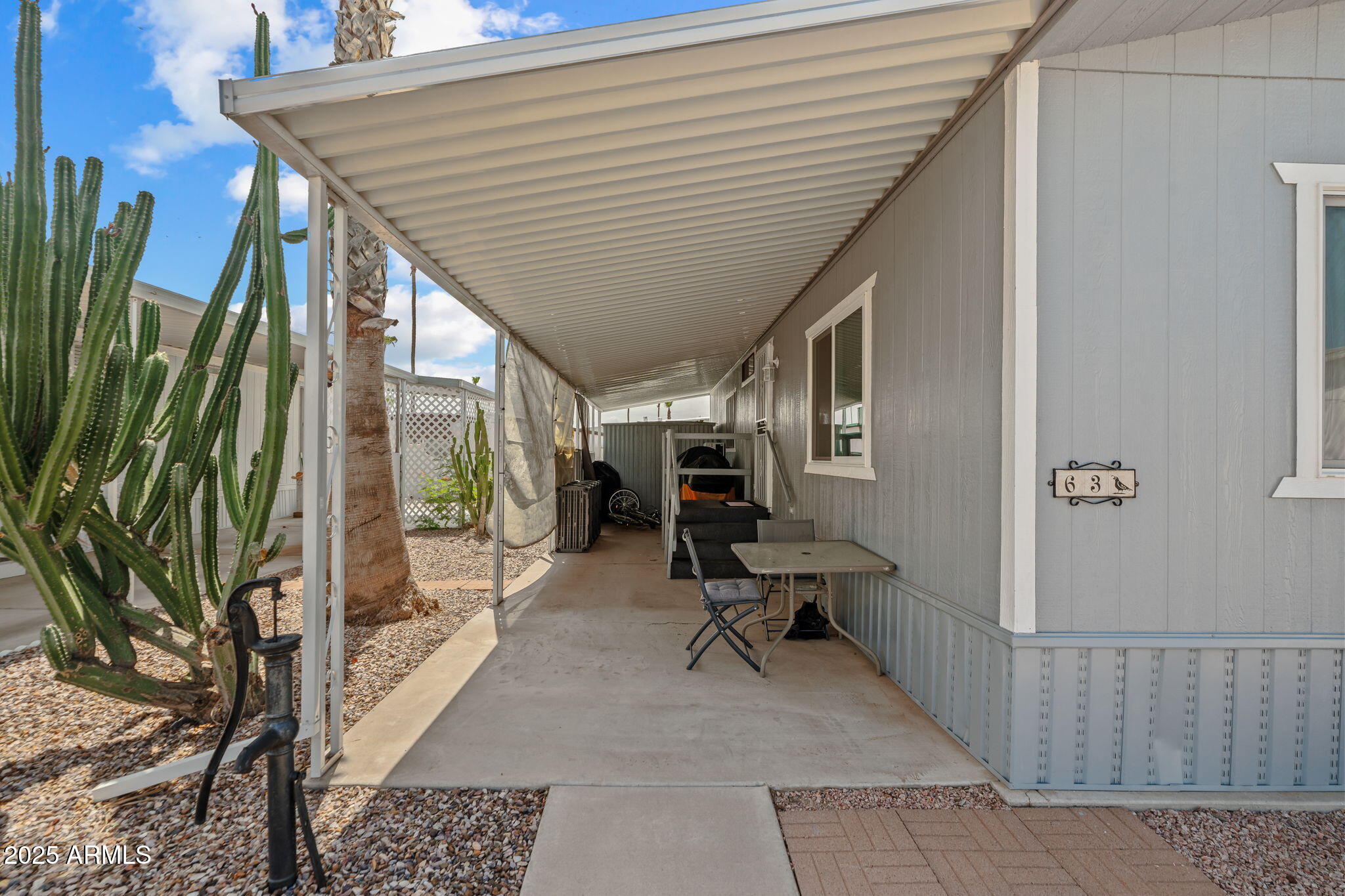 269 North Winchester Road, Unit 63 Apache Junction, AZ 85119 - Photo 17 of 18 a balcony with chairs and a potted plant
