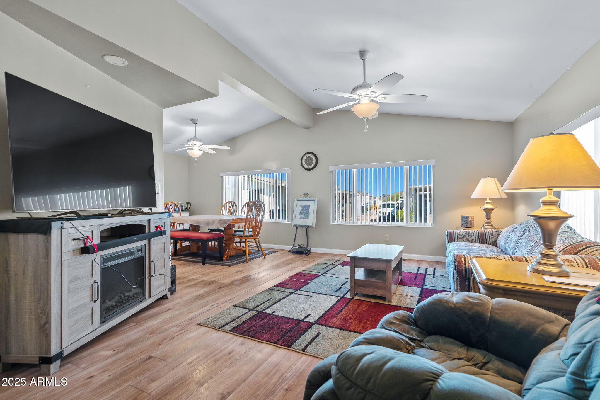 269 North Winchester Road, Unit 63 Apache Junction, AZ 85119 - Photo 2 of 18 a living room with furniture and a flat screen tv