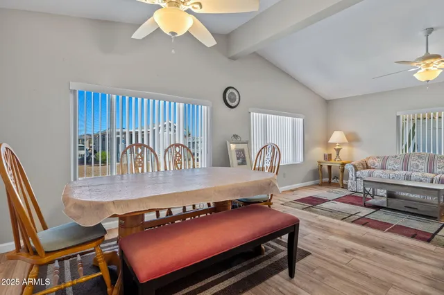 a living room with furniture a table and wooden floor