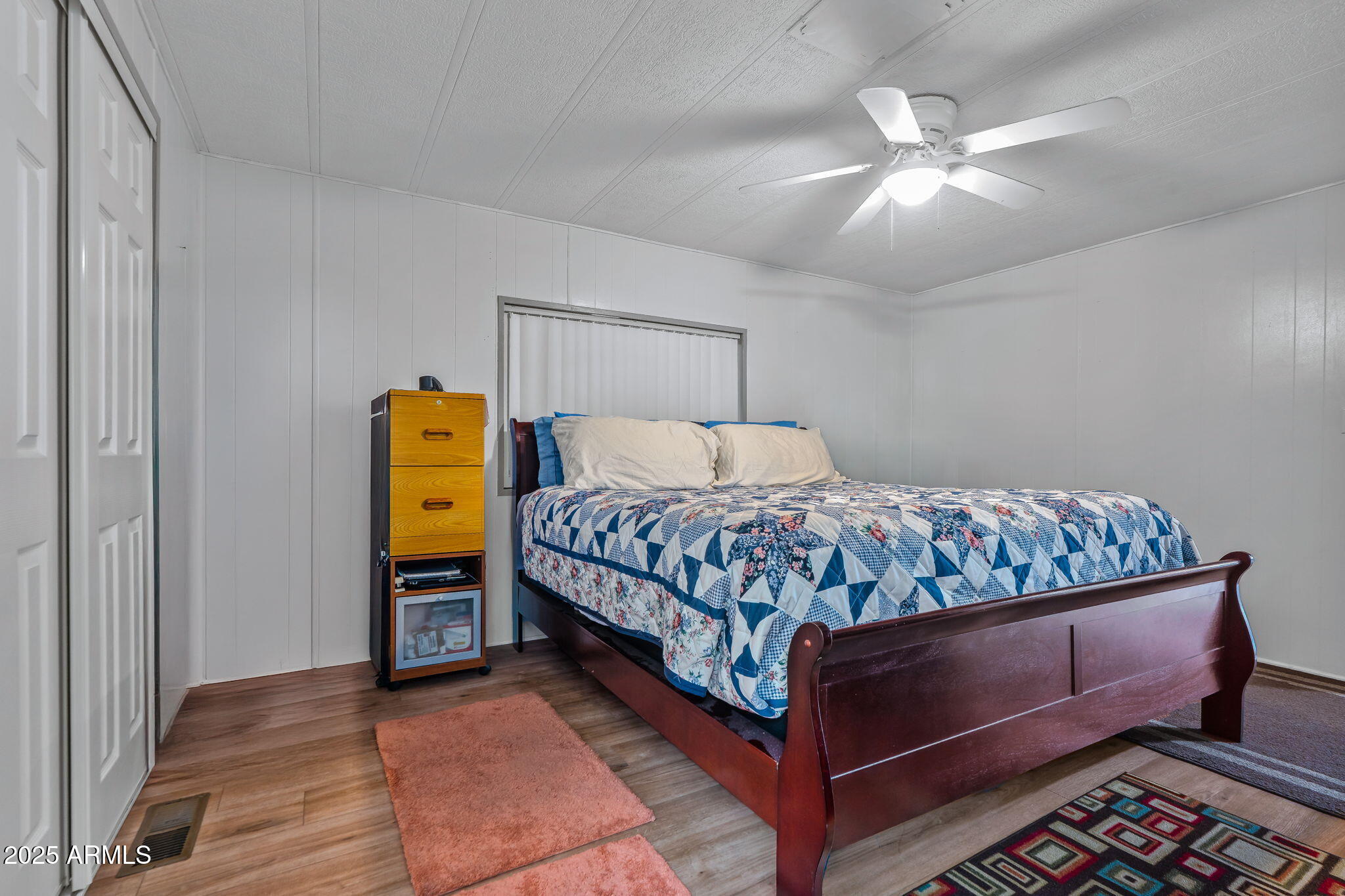 269 North Winchester Road, Unit 63 Apache Junction, AZ 85119 - Photo 7 of 18 a bedroom with a bed and a chandelier