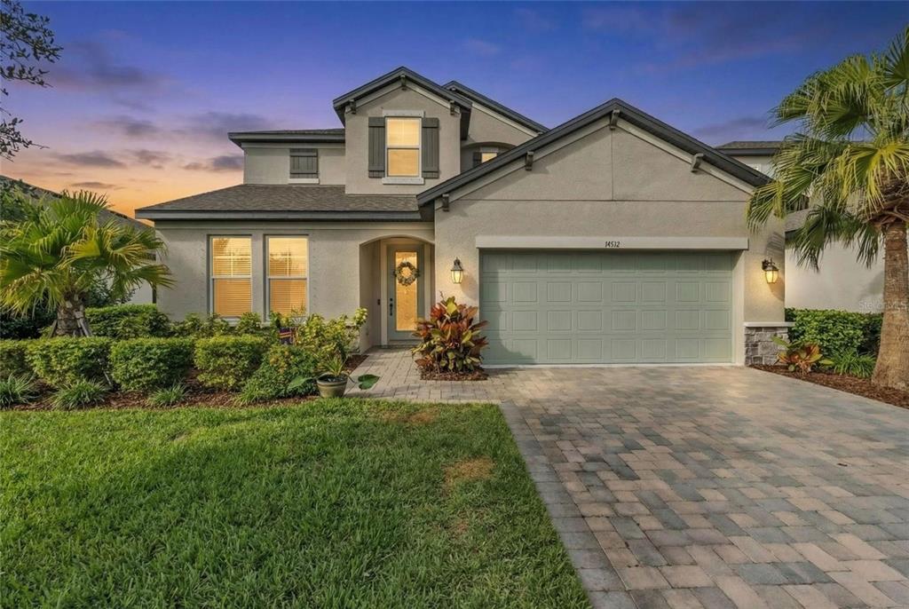 a front view of a house with a yard and garage