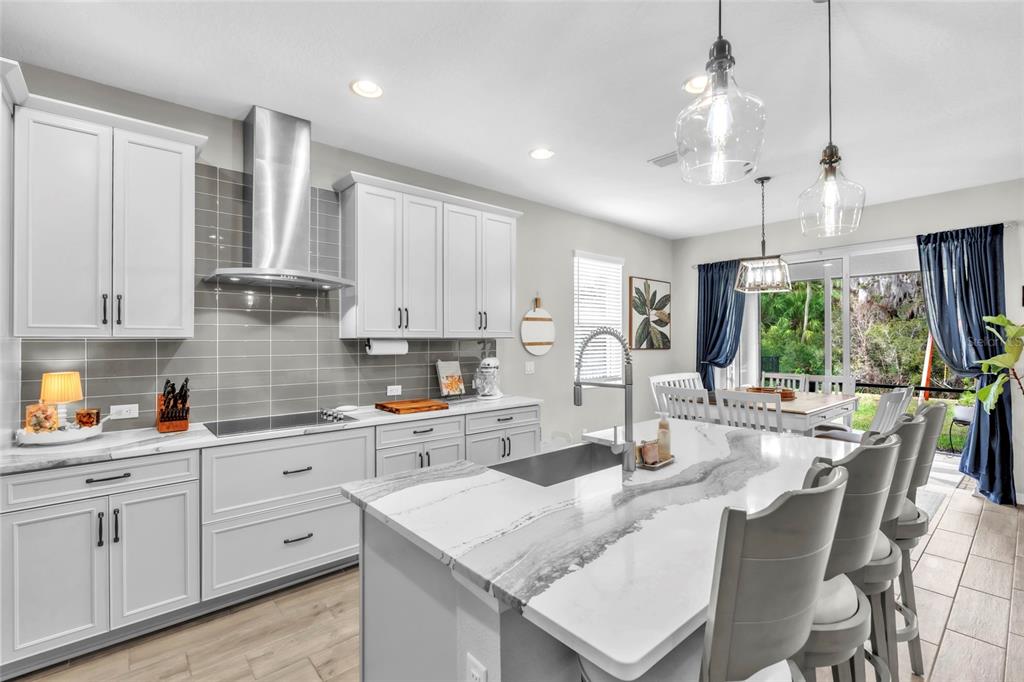 14412 20th Street East Parrish, FL 34219 - Photo 13 of 57 a kitchen with stainless steel appliances kitchen island granite countertop a sink a stove and cabinets
