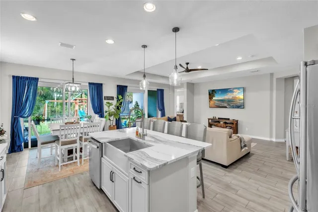 a view of a porch with chairs and potted plants