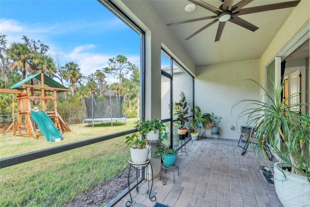 14412 20th Street East Parrish, FL 34219 - Photo 15 of 57 a view of a porch with chairs and potted plants