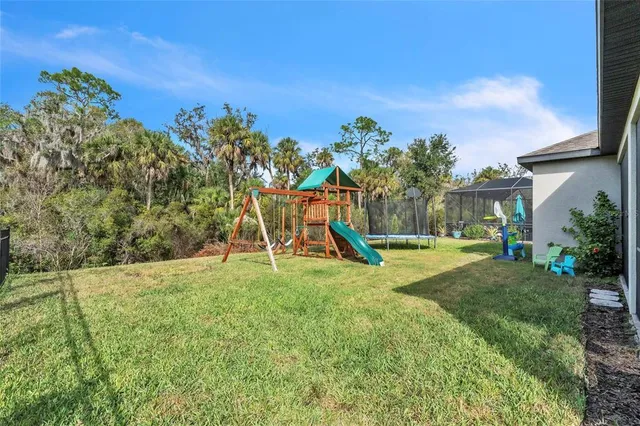 a view of a house with backyard porch and sitting area