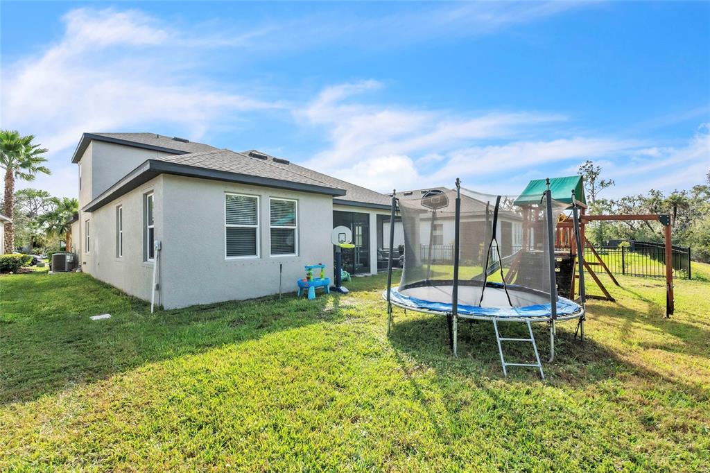14412 20th Street East Parrish, FL 34219 - Photo 20 of 57 a view of a chair and tables in the back yard of the house