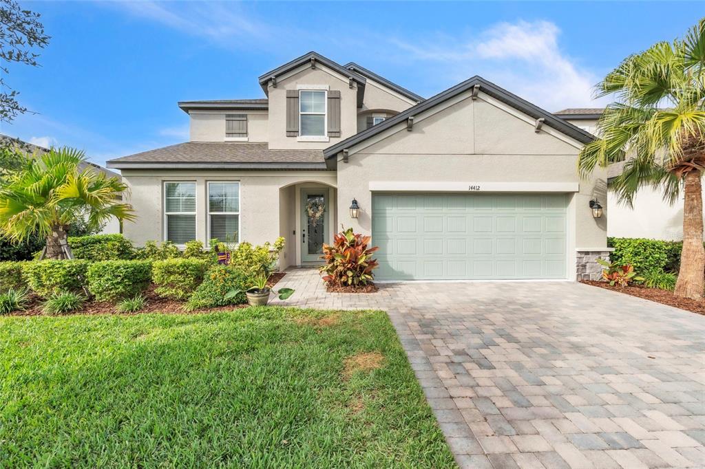 14412 20th Street East Parrish, FL 34219 - Photo 2 of 57 a front view of a house with a yard and potted plants