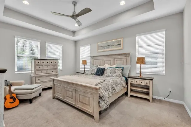 a bedroom with a bed and a chandelier