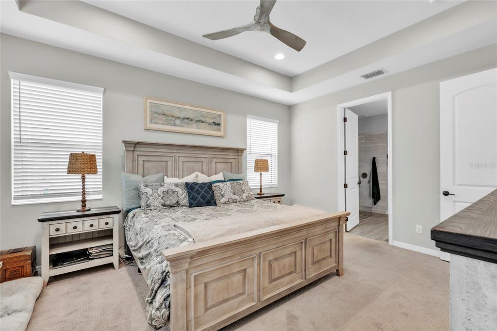 14412 20th Street East Parrish, FL 34219 - Photo 22 of 57 a bedroom with a bed and a chandelier