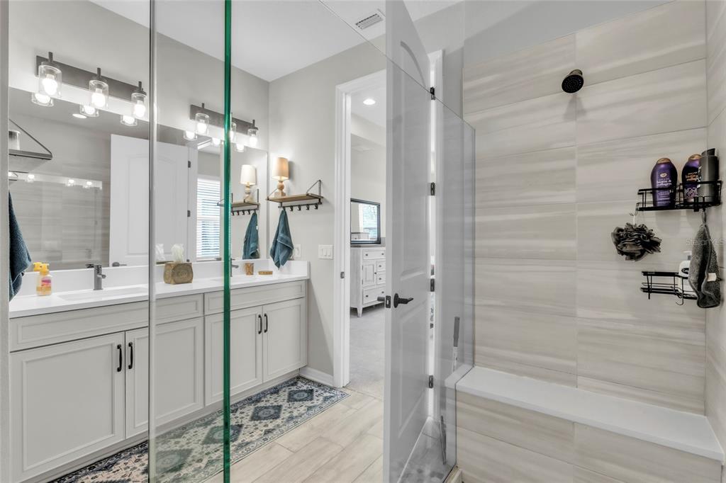 14412 20th Street East Parrish, FL 34219 - Photo 25 of 57 a bathroom with a double vanity sink a toilet and shower