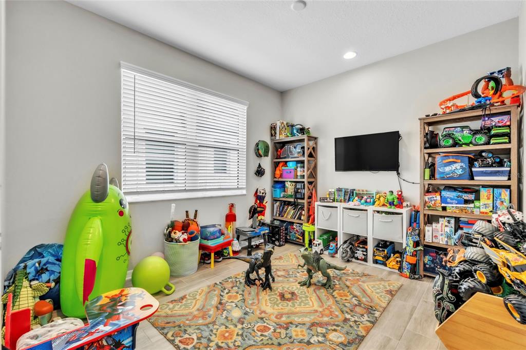 14412 20th Street East Parrish, FL 34219 - Photo 27 of 57 a playing room with toys and a flat screen tv