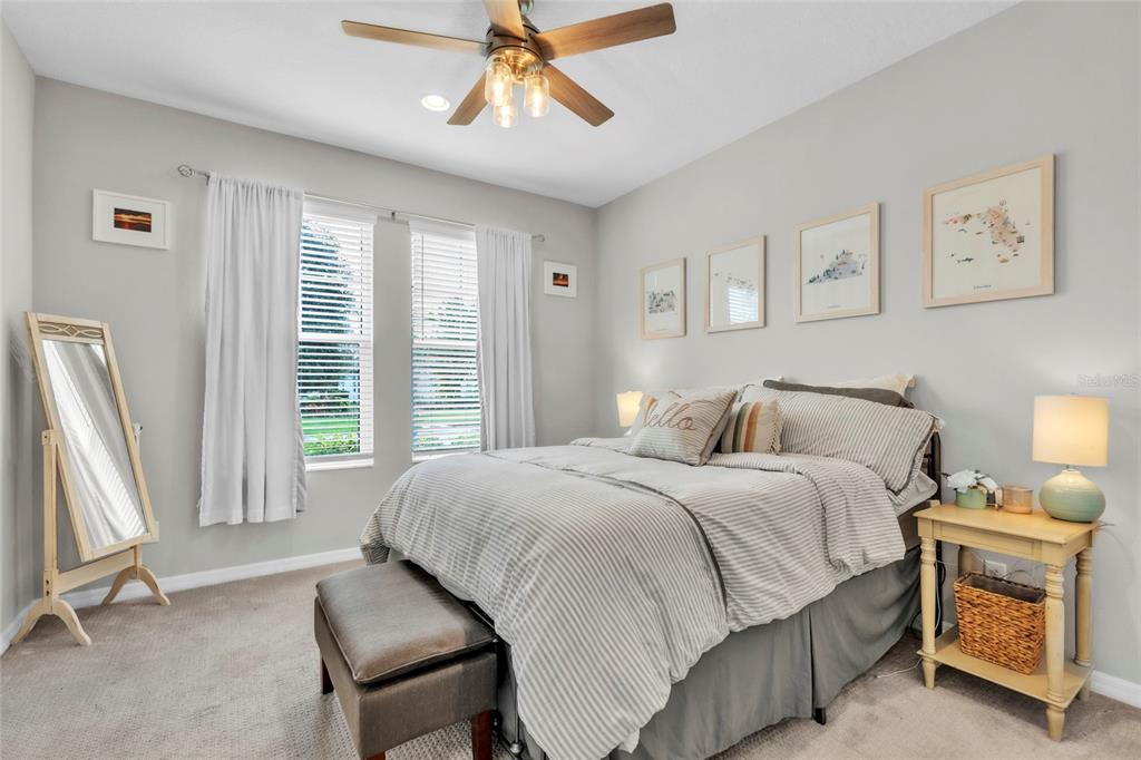 14412 20th Street East Parrish, FL 34219 - Photo 28 of 57 a bedroom with a bed and a chandelier