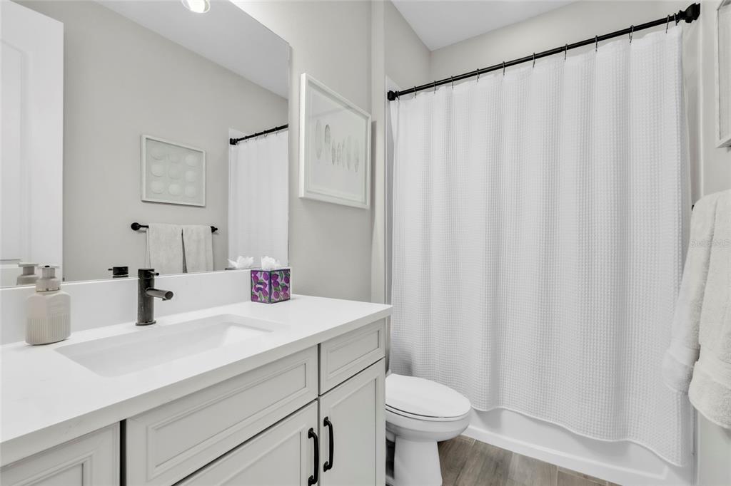 14412 20th Street East Parrish, FL 34219 - Photo 30 of 57 a bathroom with a sink and a mirror