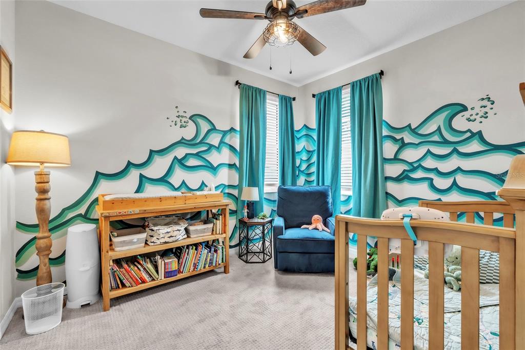 14412 20th Street East Parrish, FL 34219 - Photo 37 of 57 a bedroom with furniture and a baby crib