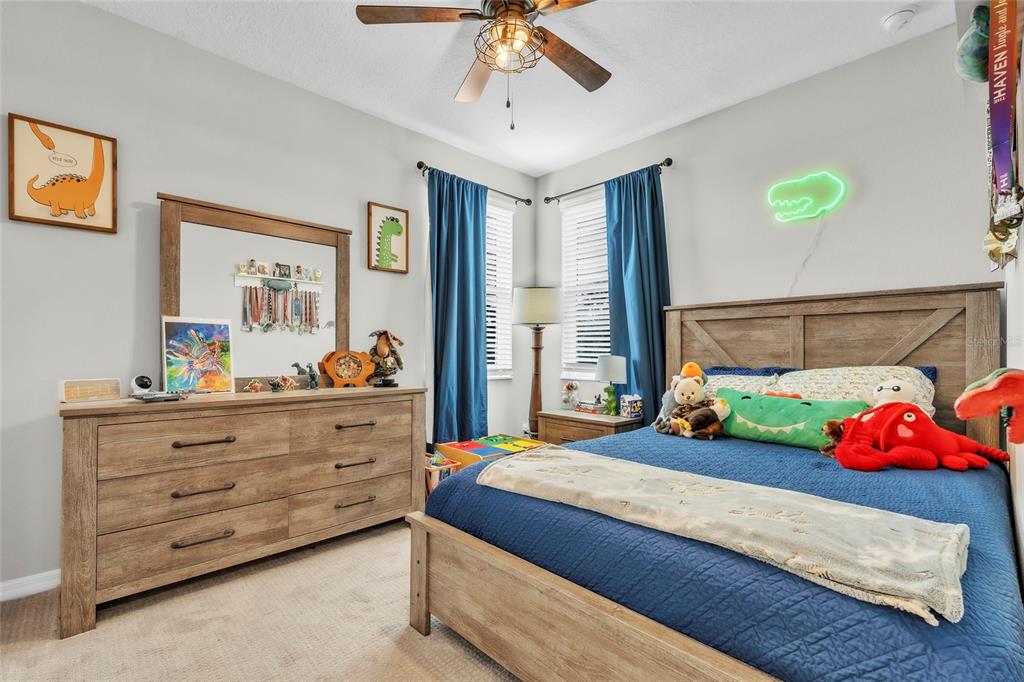 14412 20th Street East Parrish, FL 34219 - Photo 41 of 57 a bedroom with a bed and a chandelier