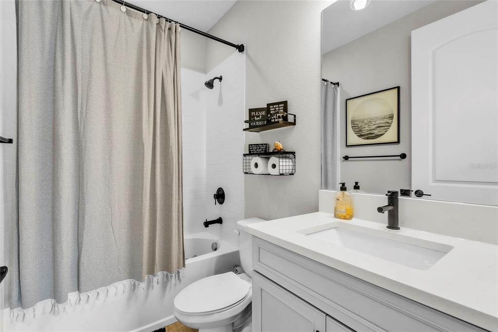 14412 20th Street East Parrish, FL 34219 - Photo 42 of 57 a bathroom with a sink a toilet and shower curtain