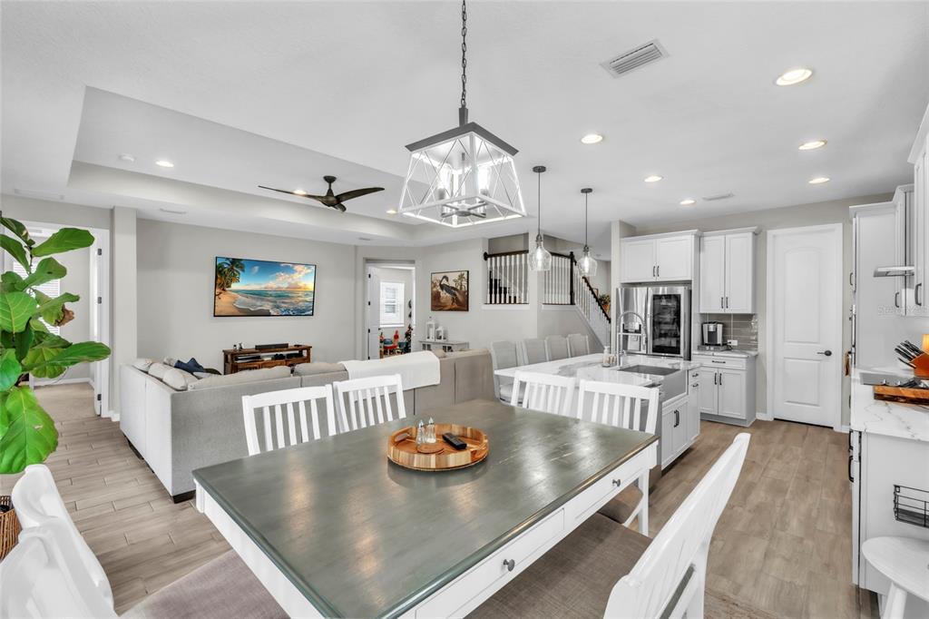 14412 20th Street East Parrish, FL 34219 - Photo 9 of 57 a view of a dining room and livingroom with furniture wooden floor a chandelier